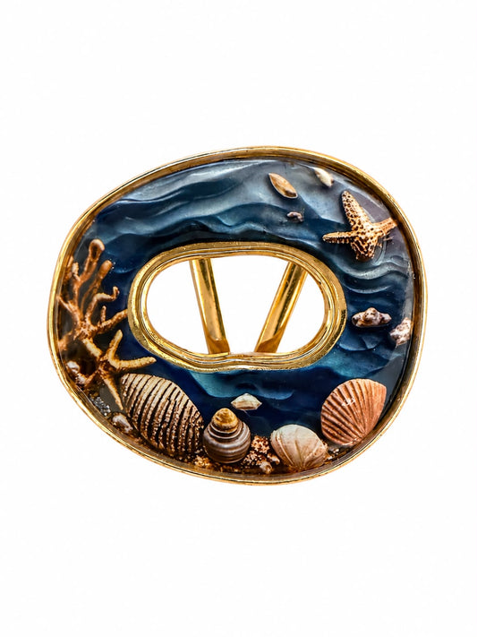 HEBILLA DORADA CON MAR AZUL